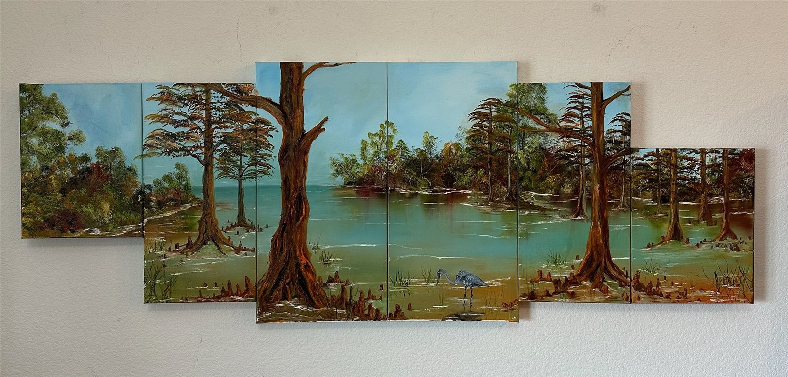 Oil painting collage of a cypress swamp spanning six canvases, a heron wading among ancient trees in green-blue water.